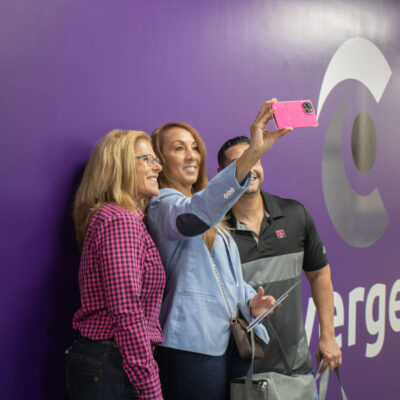 Two women and a man clicking selfie